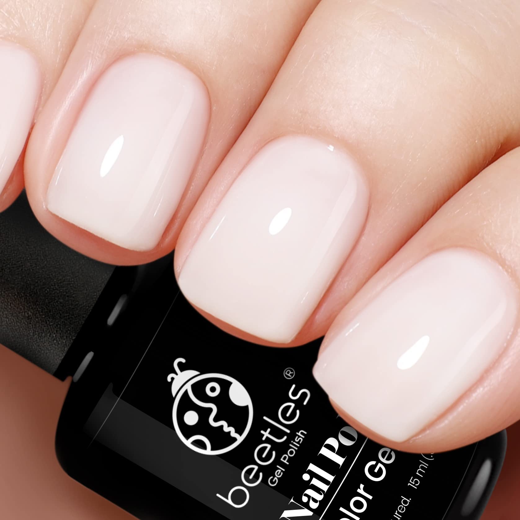 Beetles Milky White gel nail polish bottle beside a long-wear manicure demo.