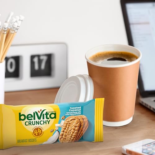 Belvita Toasted Coconut biscuits beside a steaming cup of coffee.