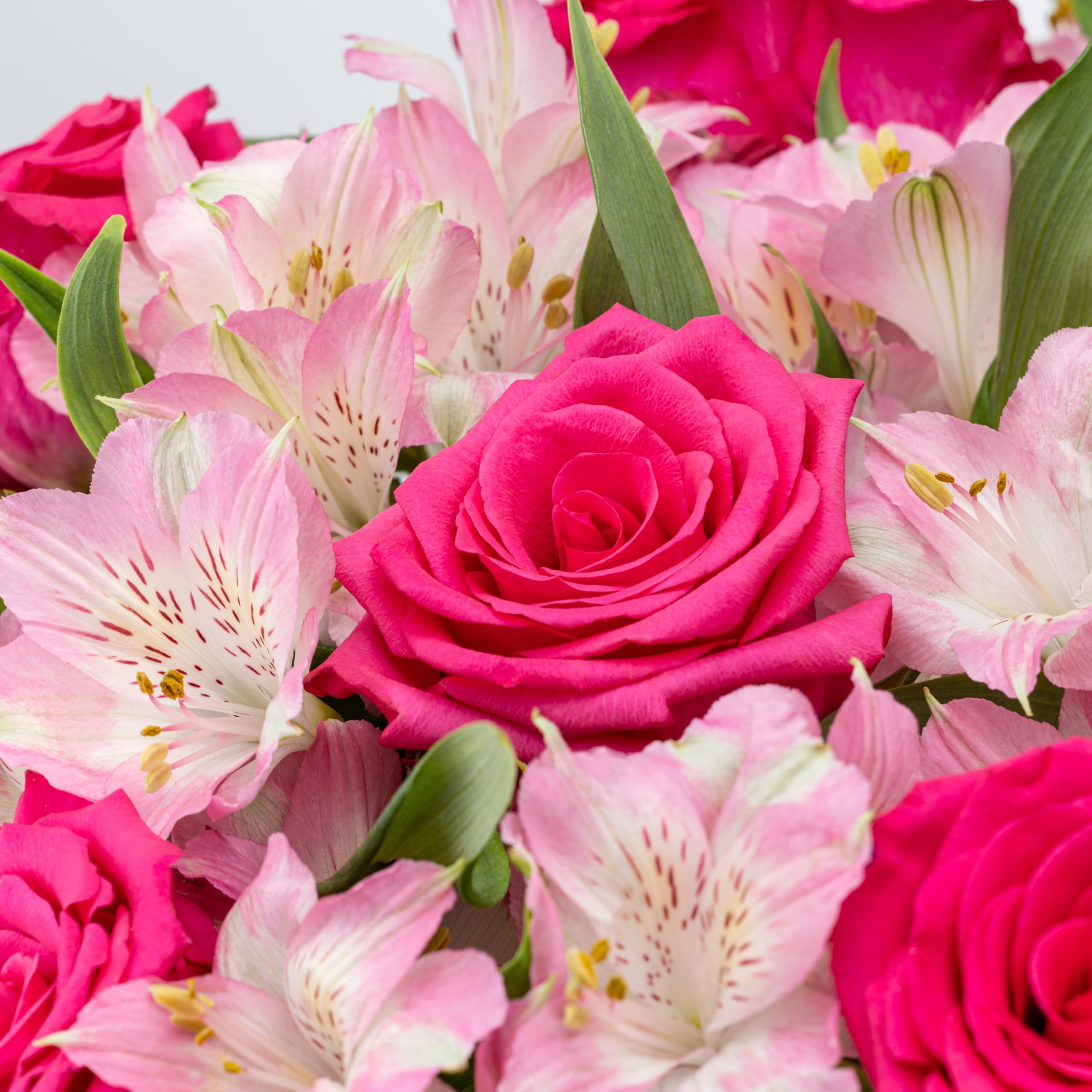 Benchmark Bouquets bouquet in a clear glass vase ready to display at home.