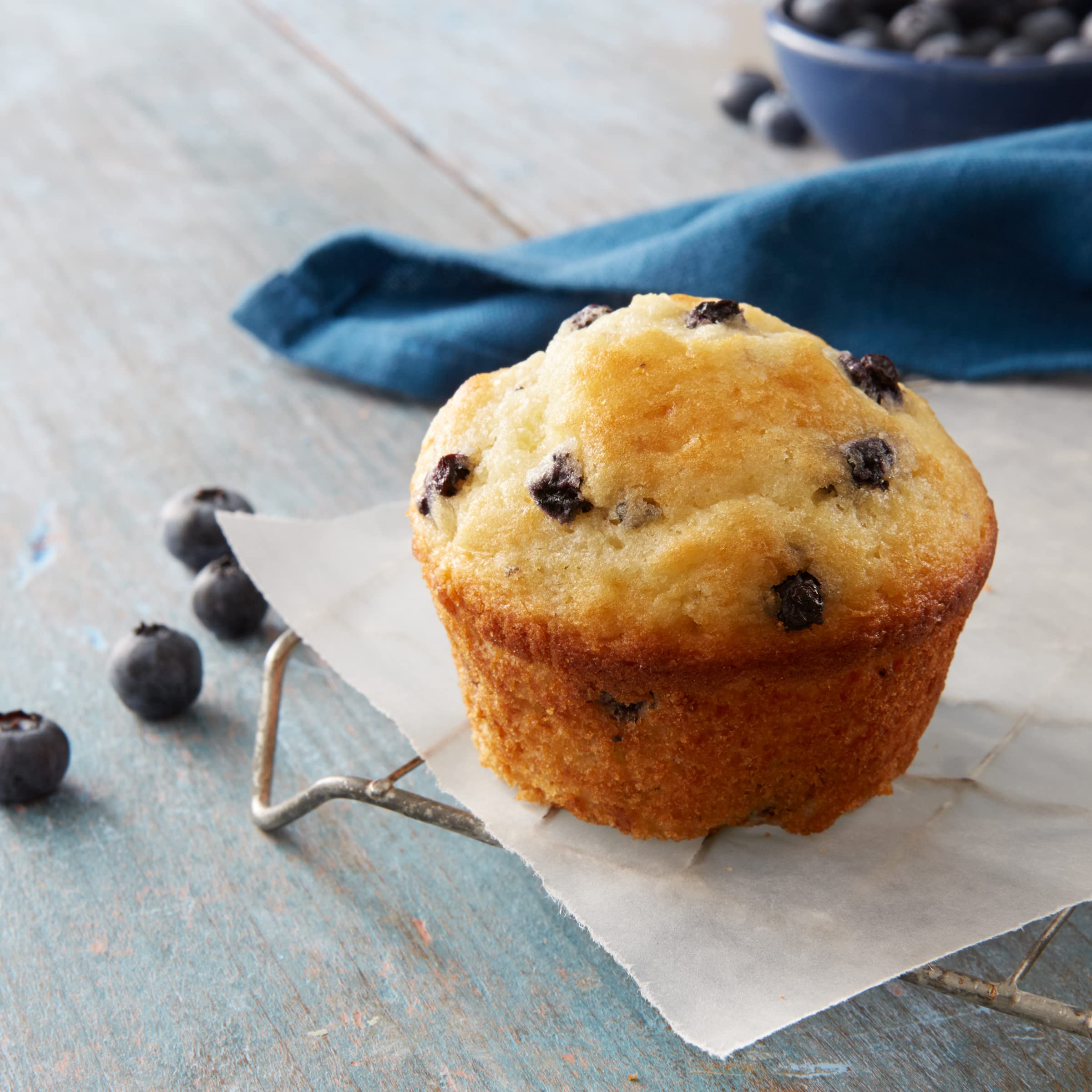 Betty Crocker Blueberry Muffin Mix oven-baking scene with golden muffins.