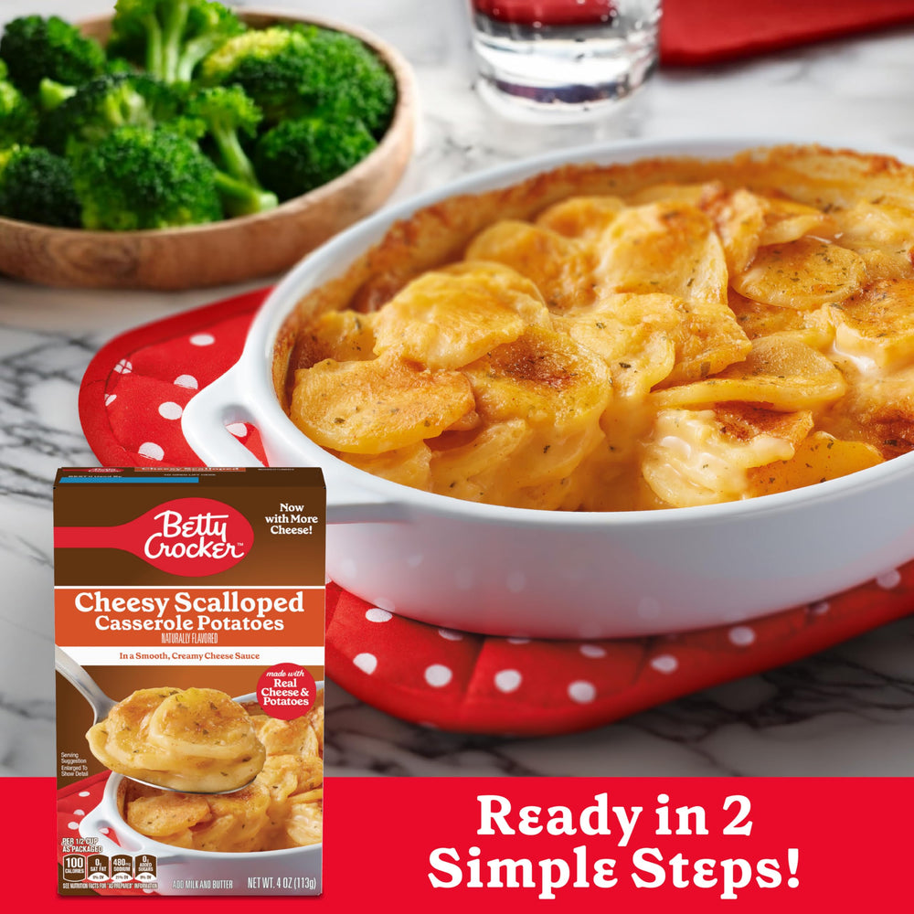 Betty Crocker Cheesy Scalloped Potatoes in a cooking pot with creamy sauce.