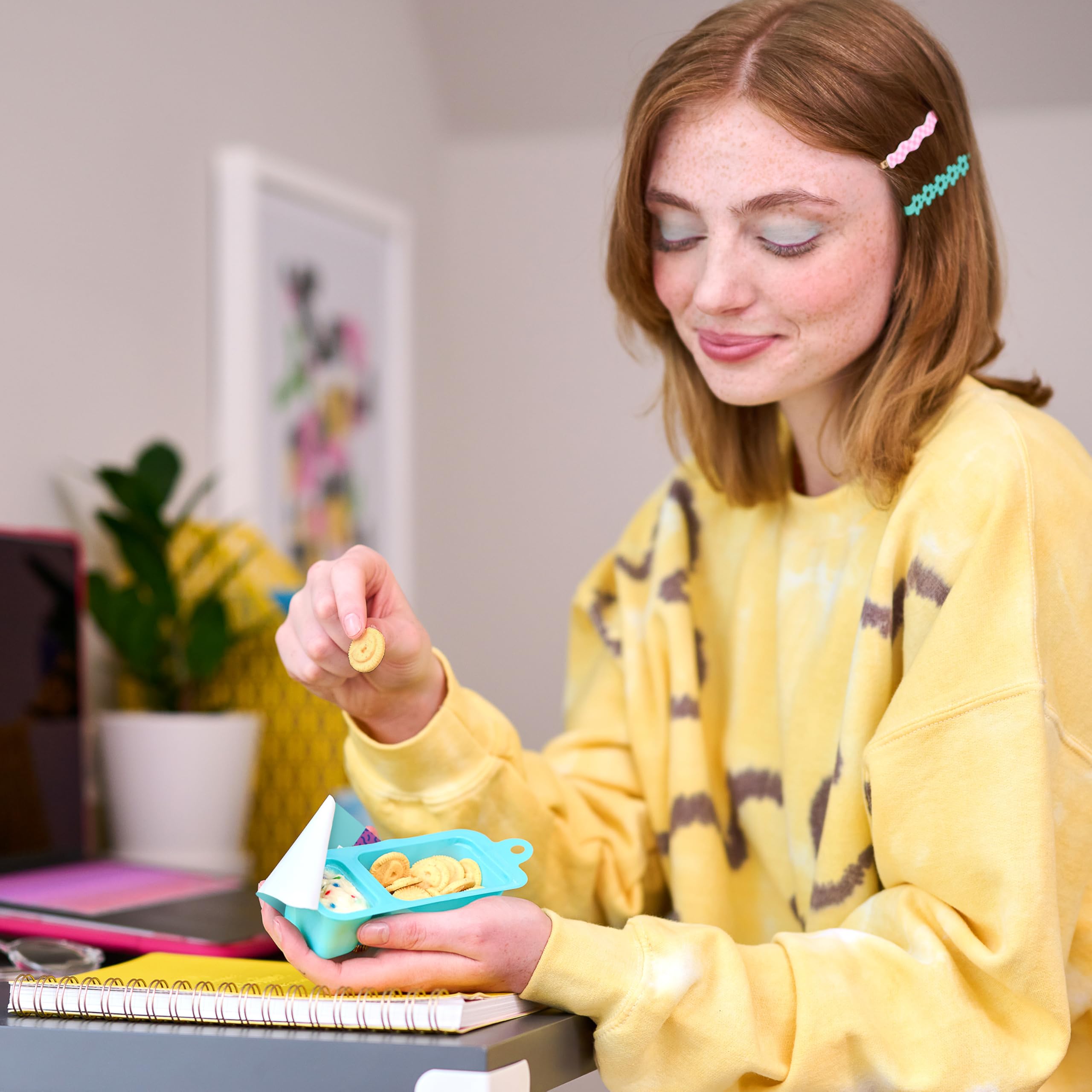 Kids dipping cookies into frosting, hands-on snack time delight.