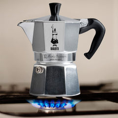 Pouring espresso from the Bialetti Moka Express into a cup.