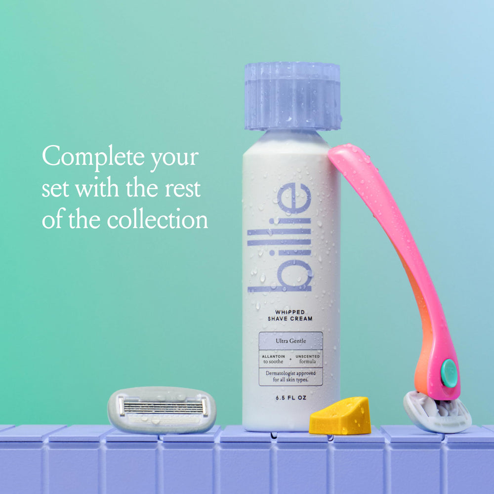 Billie razor gliding over fluffy foam for a smooth shave.