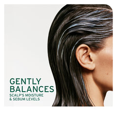 Biolage Scalp Sync close-up shows dandruff flakes addressed by formula.