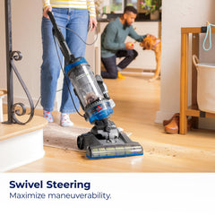 Bissell CleanView Swivel Rewind extension wand reaching under furniture.