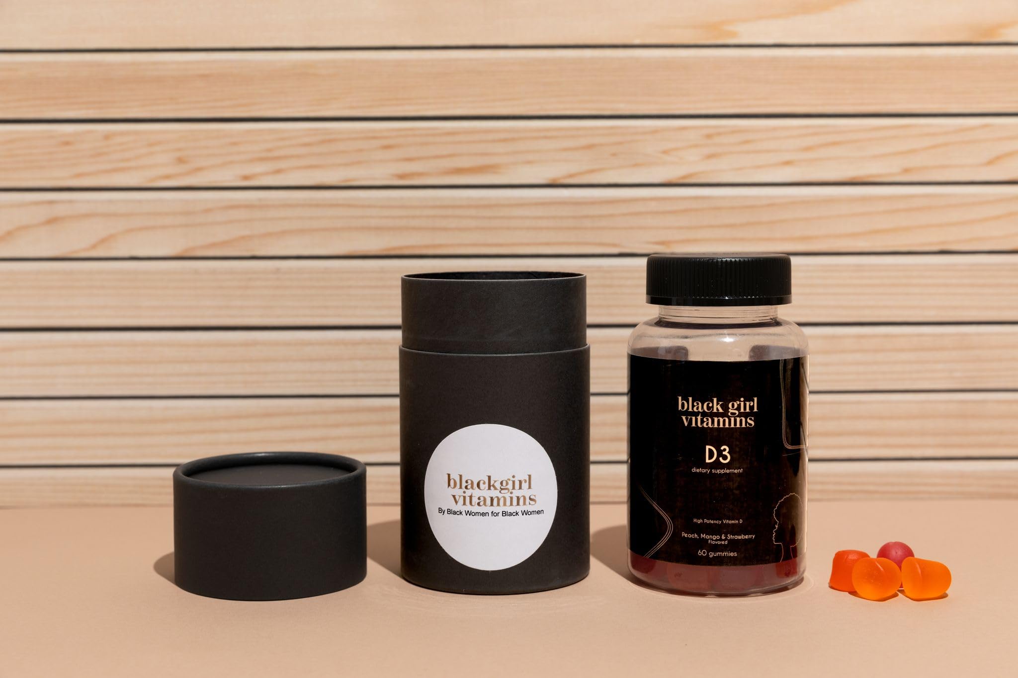 Black Girl Vitamins D3 Gummies bottle being held, ideal for on-the-go routines.