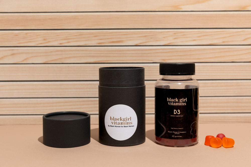 Black Girl Vitamins D3 Gummies bottle being held, ideal for on-the-go routines.