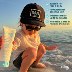 Child playing in water with Bliss sunscreen ready for splash and 80-minute water resistance.
