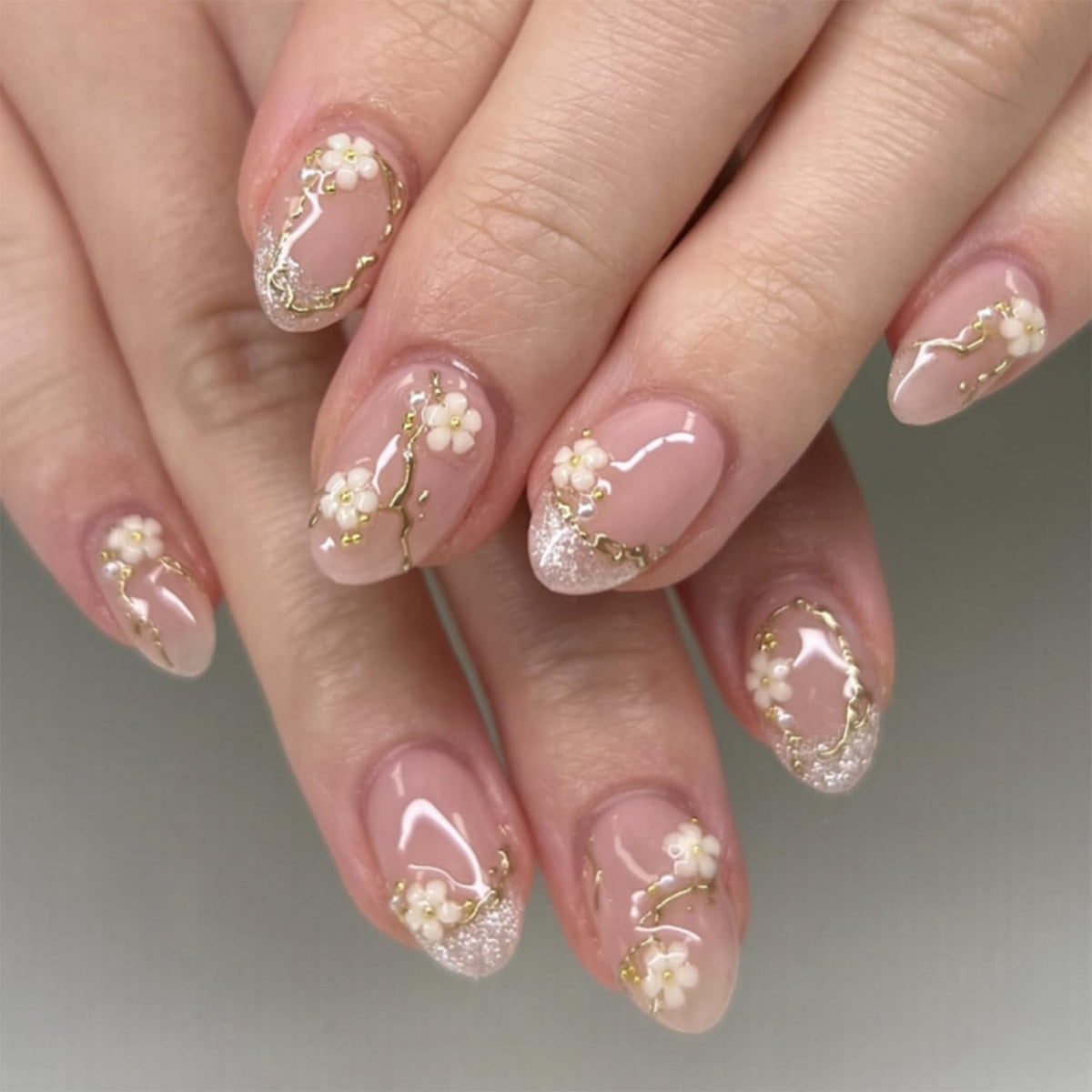 Bloazife nude pink flower press-on nails in almond shape for a quick, salon-like manicure.