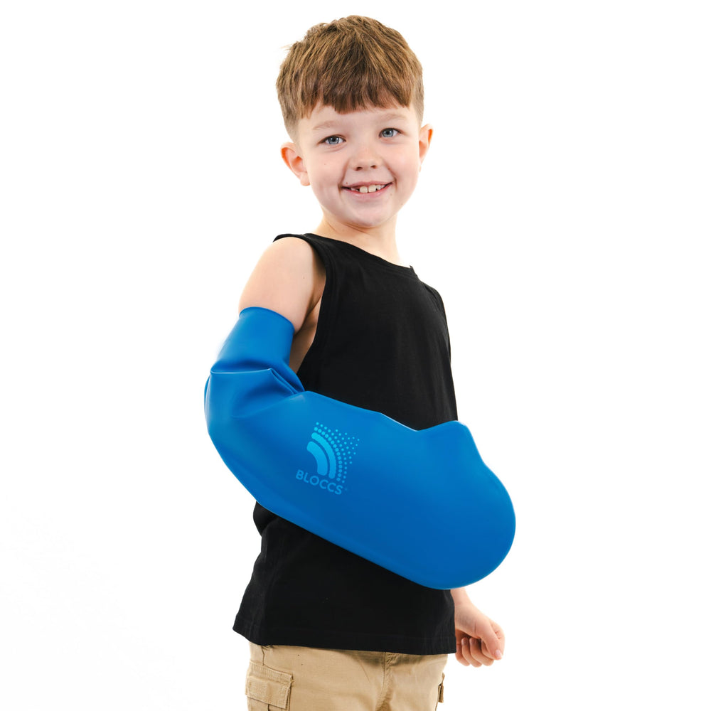BLOCCS arm cast cover for kids worn during activity to stay dry.