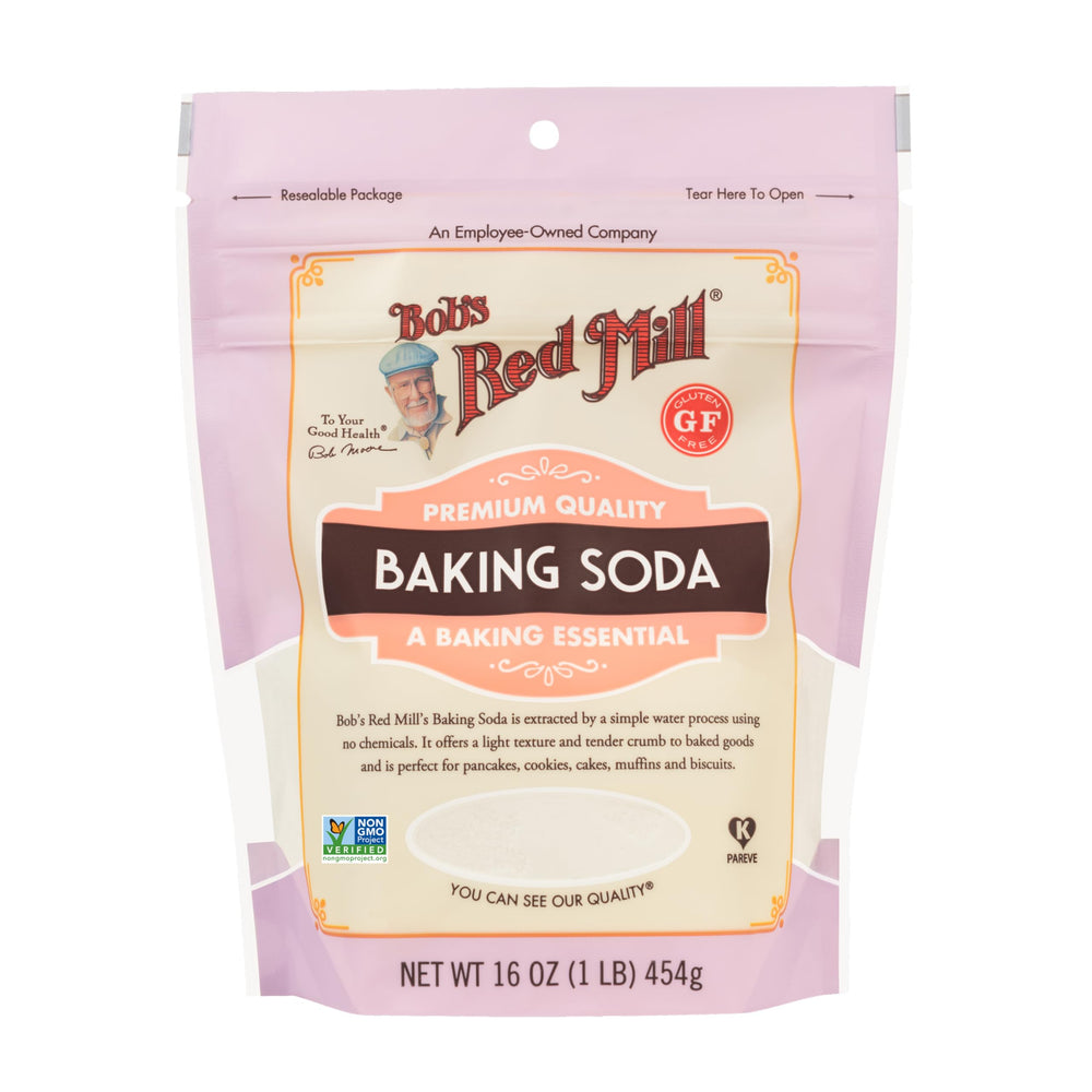 Pouring Bob's Red Mill baking soda into batter for rise.
