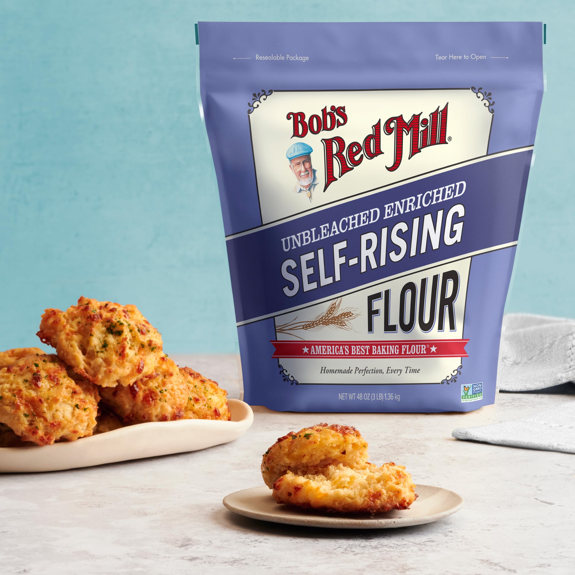 Bob's Red Mill Self-Rising Flour canister beside measuring spoons on countertop