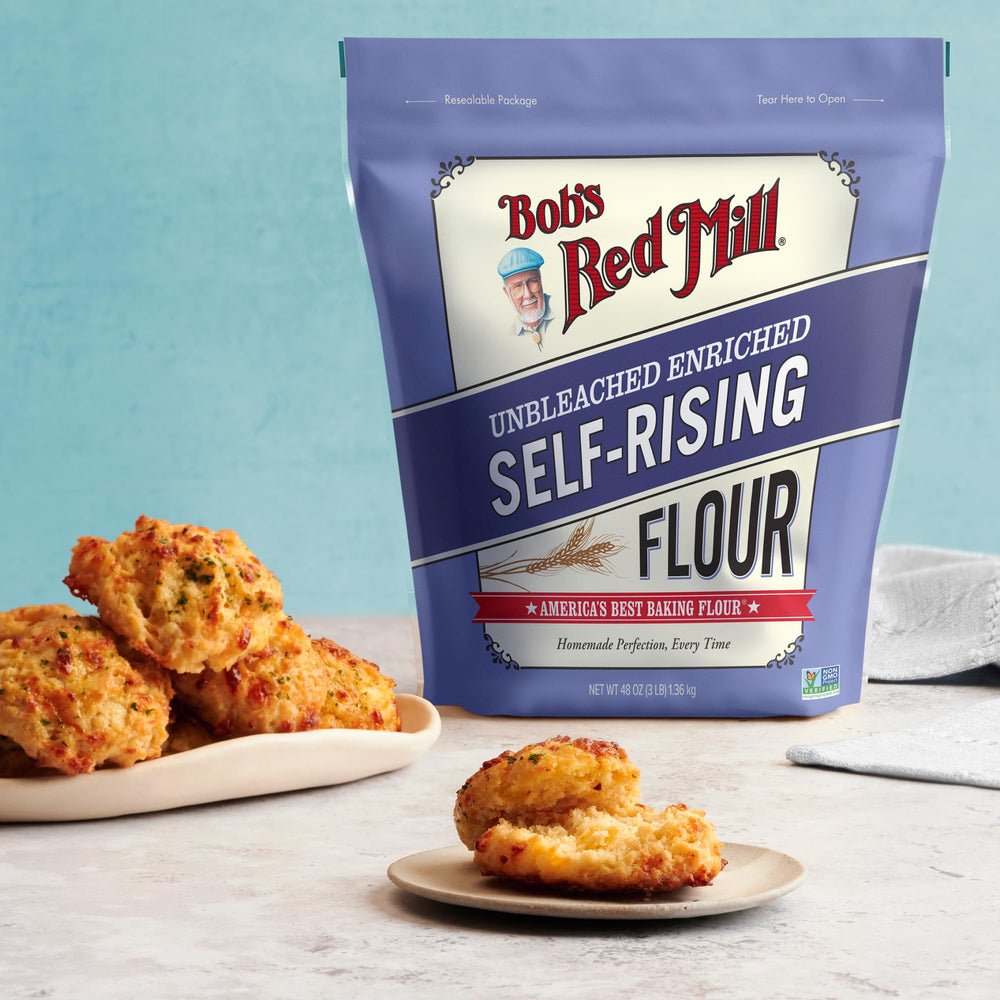 Bob's Red Mill Self-Rising Flour canister beside measuring spoons on countertop