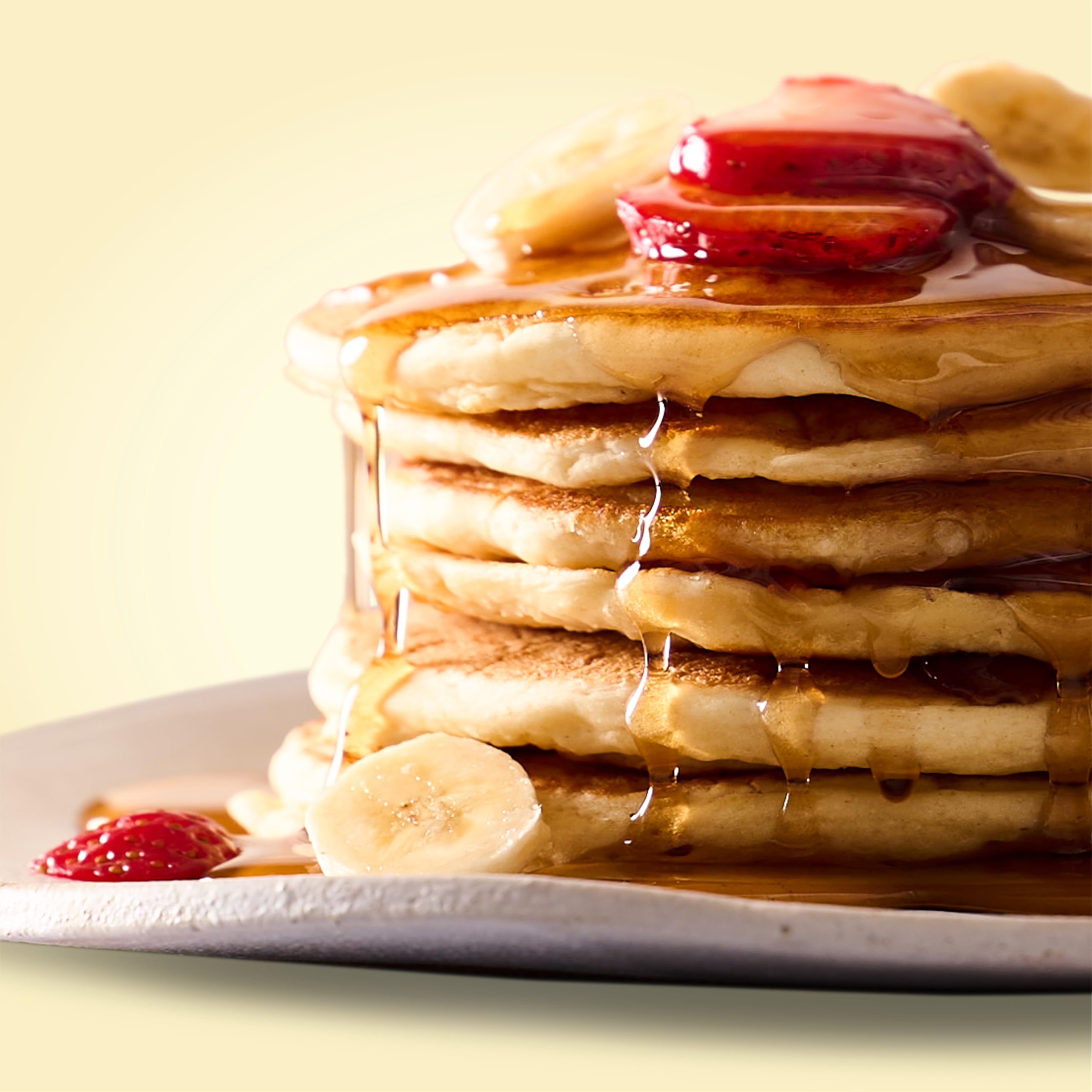 Plate of pancakes with maple syrup and berries made from Bob's Red Mill mix.