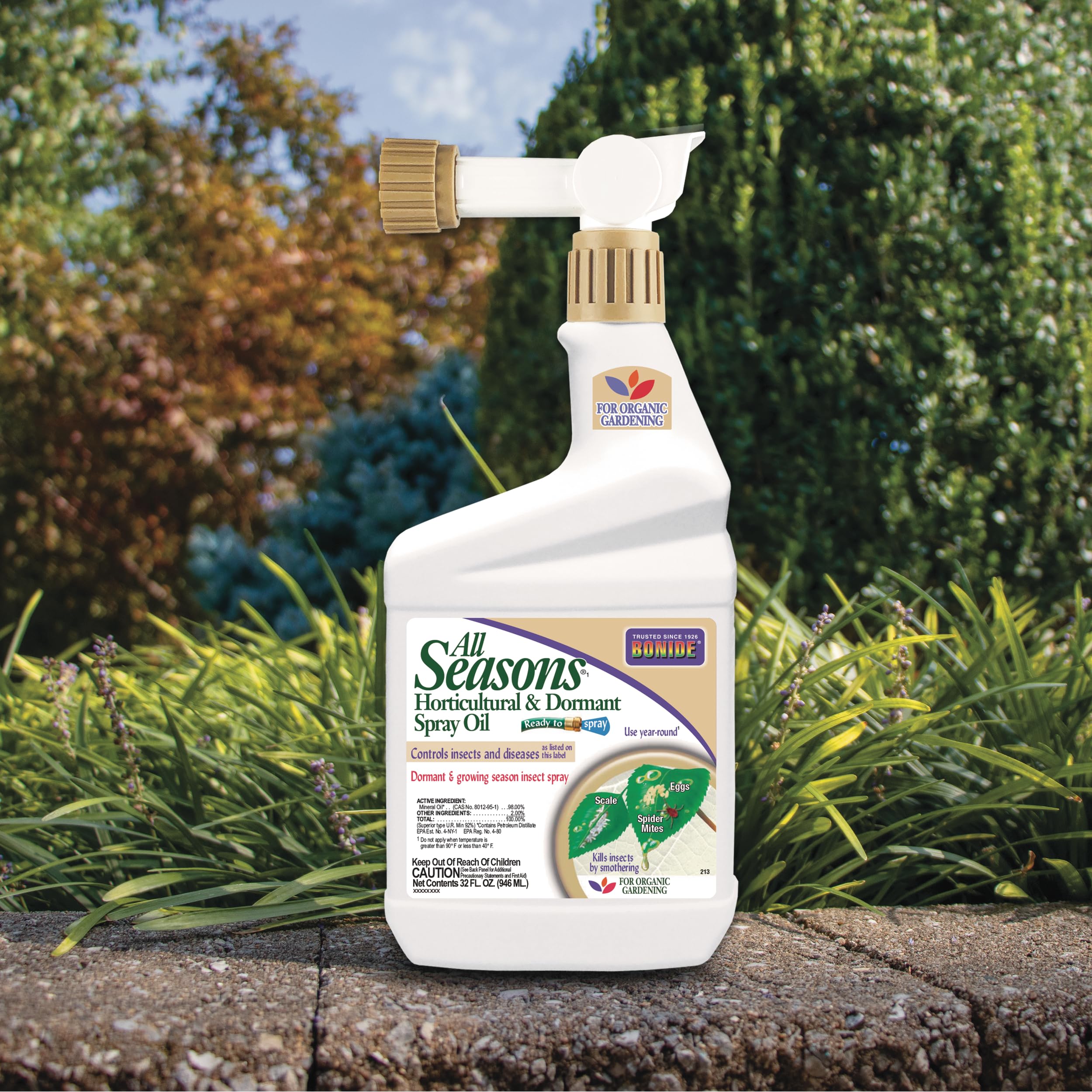 Bonide All Seasons Spray Oil demonstrates spraying action to coat and smother pests.