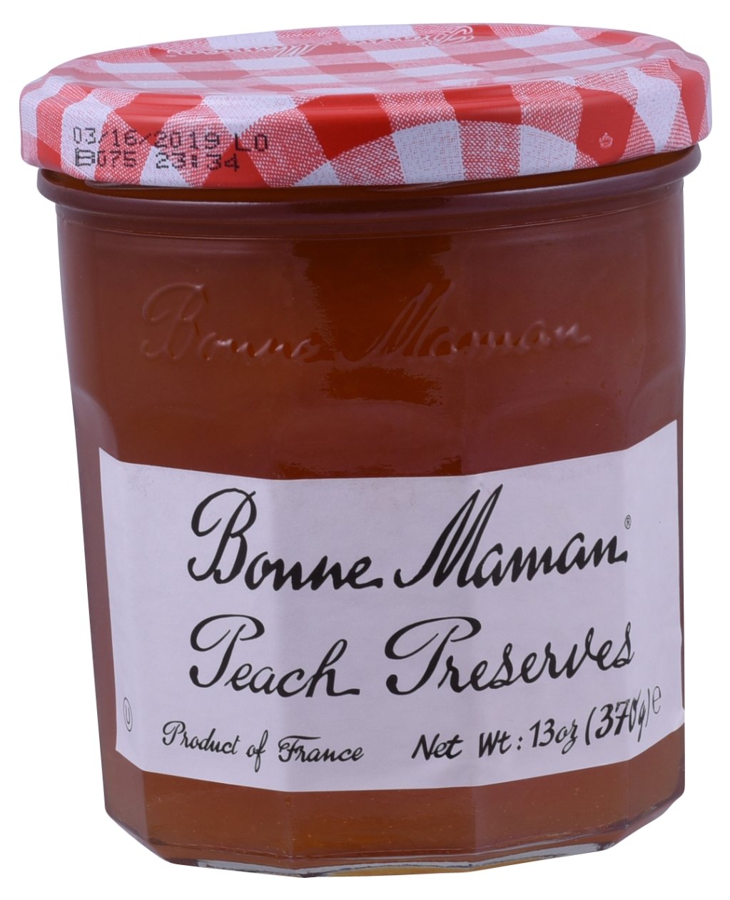 Bonne Maman Peach Preserve jar on a rustic surface, vivid peach flavor, ideal for toast.