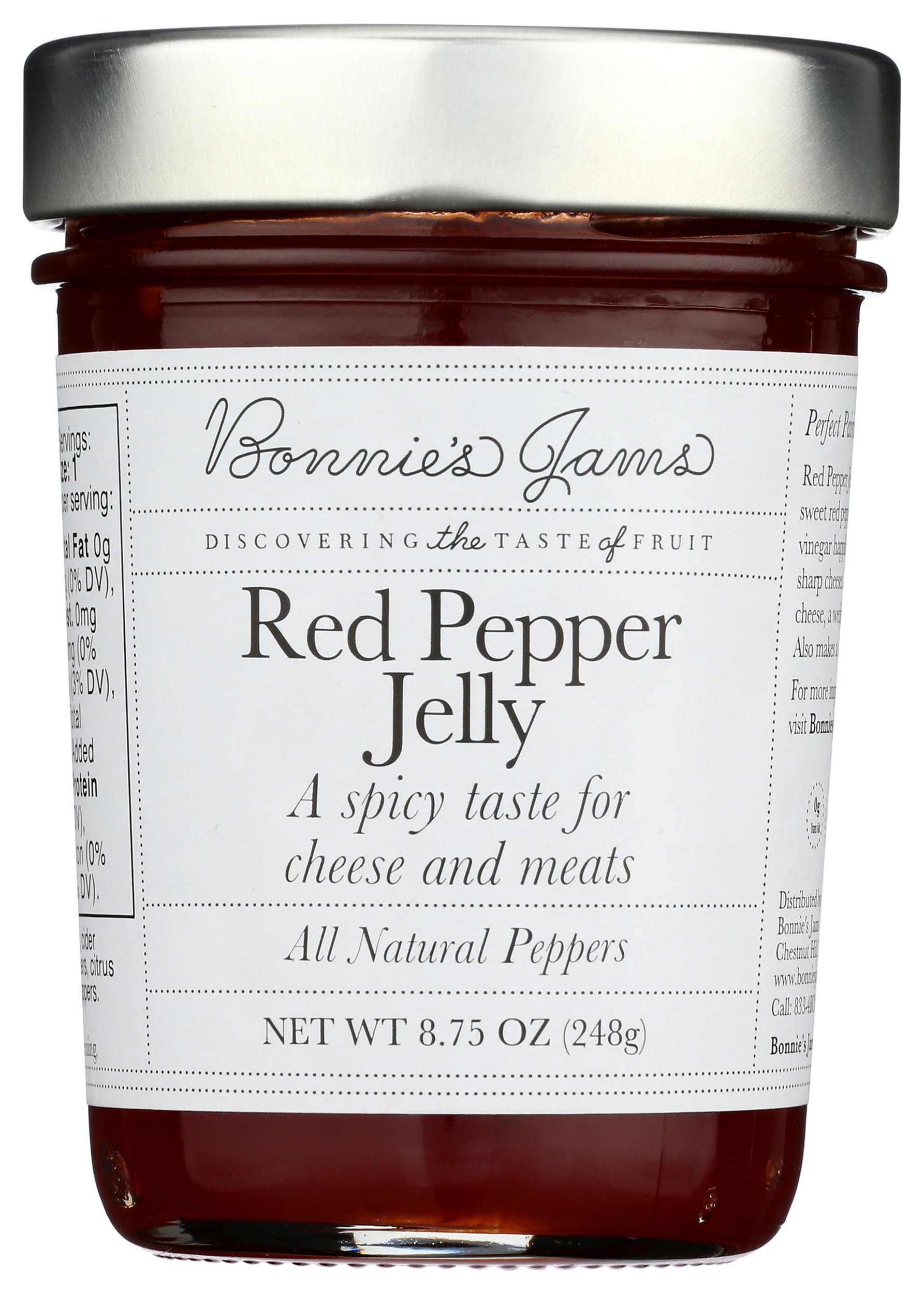 Bonnie's Jams Red Pepper Jelly jar on a cheese board for pairing.