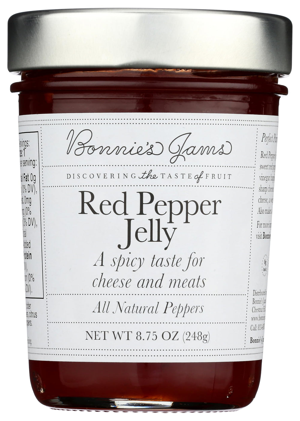 Bonnie's Jams Red Pepper Jelly jar on a cheese board for pairing.