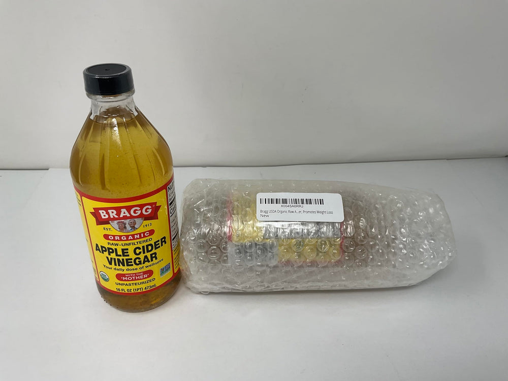 Bragg Apple Cider Vinegar bottle pour highlighting the Mother