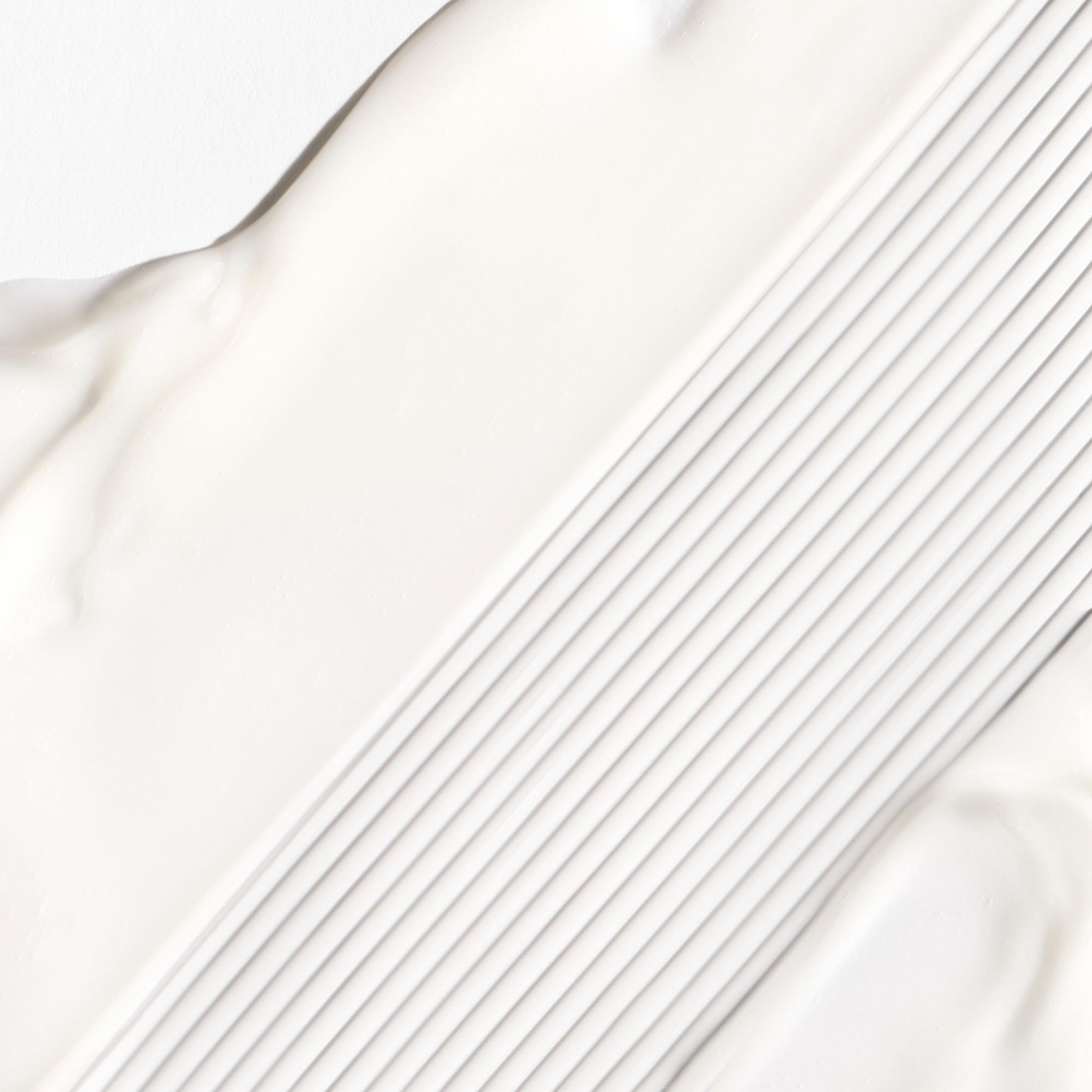 Briogeo Don't Despair, Repair cream texture highlights silky slip for styling.