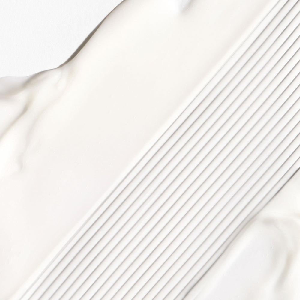 Briogeo Don't Despair, Repair cream texture highlights silky slip for styling.