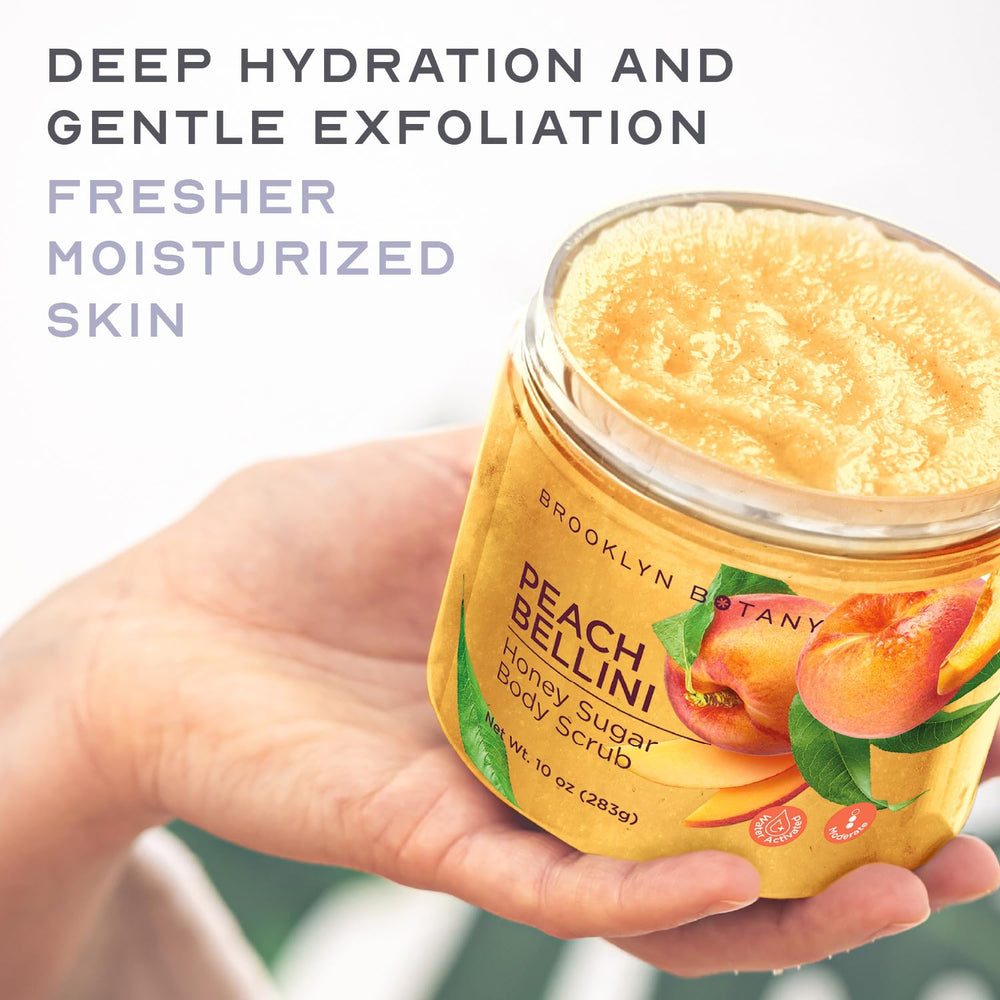 Brooklyn Botany Peach Bellini bottle beside peaches emphasizes a fruity, refreshing scent.