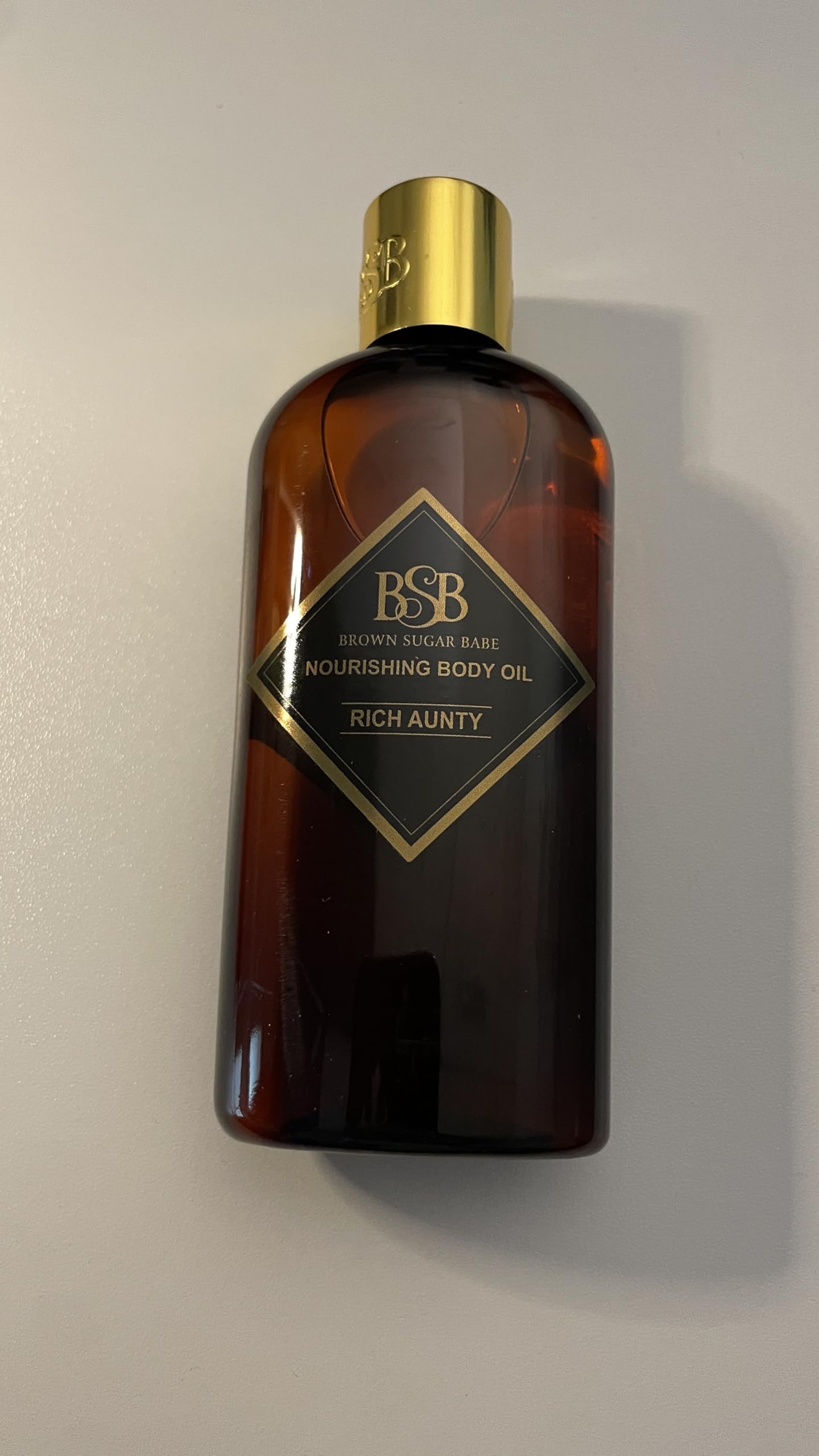 Lifestyle scene with oil on hand suggests fragrance layering daily.