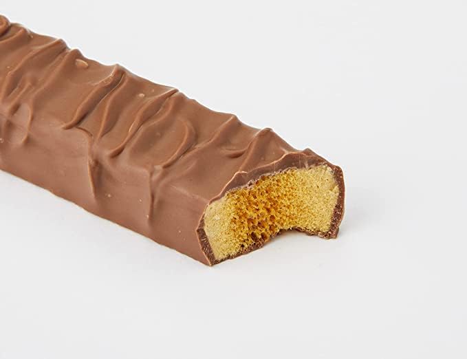 Close-up of a Crunchie bite showing the honeycomb crack and chocolate coating.