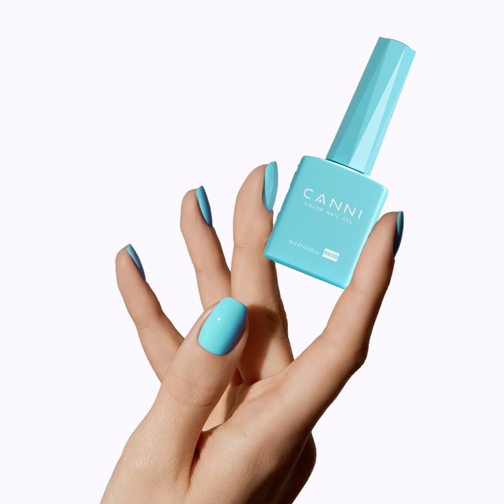CANNI Pastel Blue nails at home with a glossy finish.