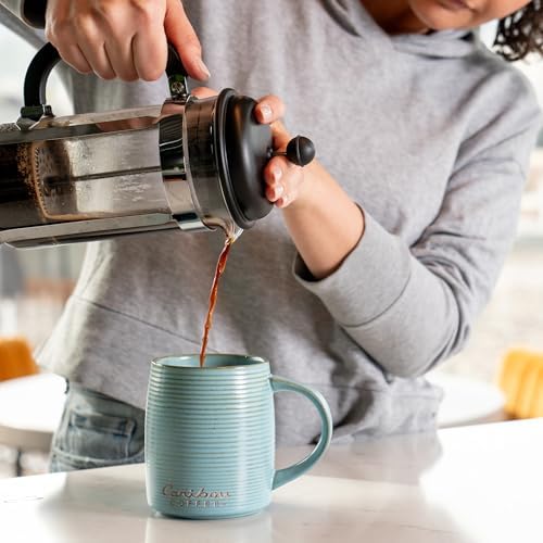 Caribou Coffee open bag reveals fresh grounds ready for brewing creativity.
