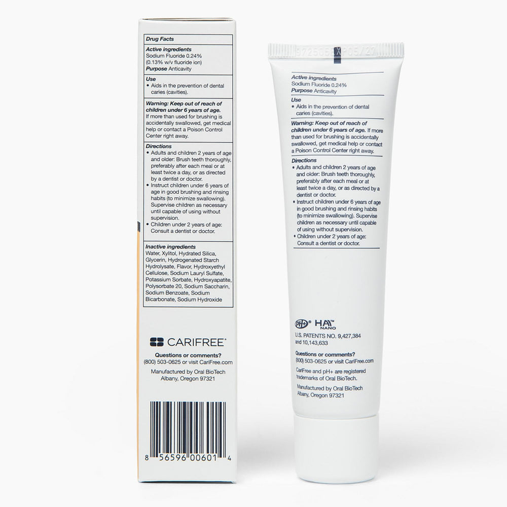 CariFree Gel 1100 citrus toothpaste being spread on a toothbrush for daily use.