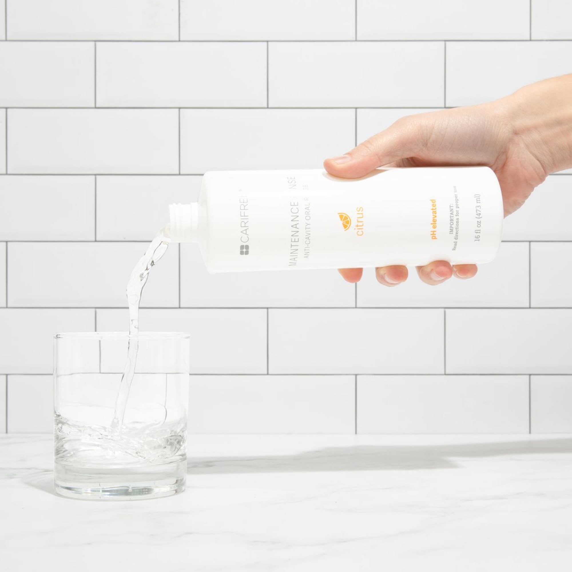 CariFree Maintenance Rinse citrus aroma imagery suggests refreshing breath potential.