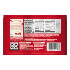 Pouring Carnation Evaporated Milk from a glass highlighting creamy texture for sauces.