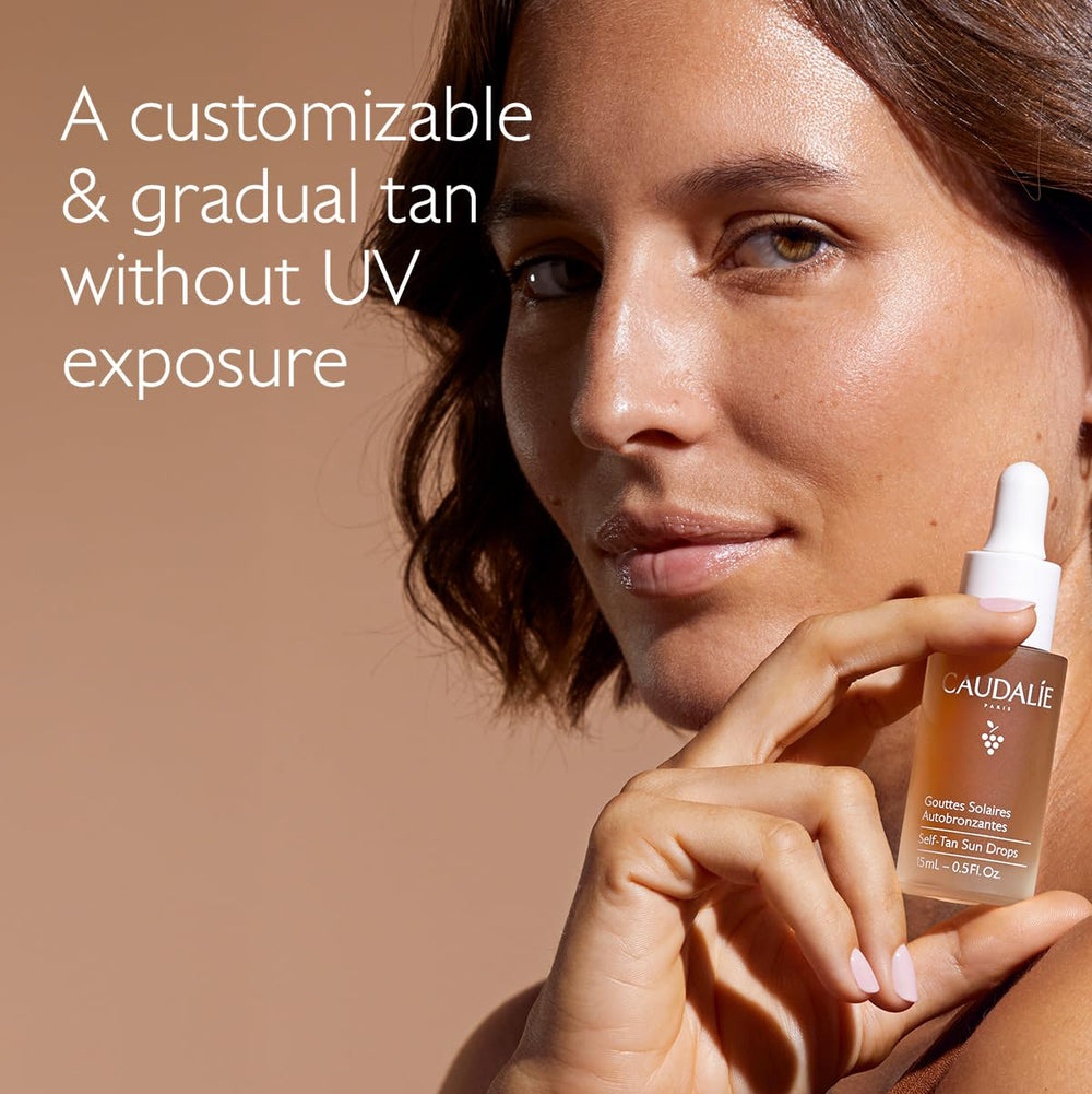 Caudalie Self-Tan Sun Drops drops on skin for customization.