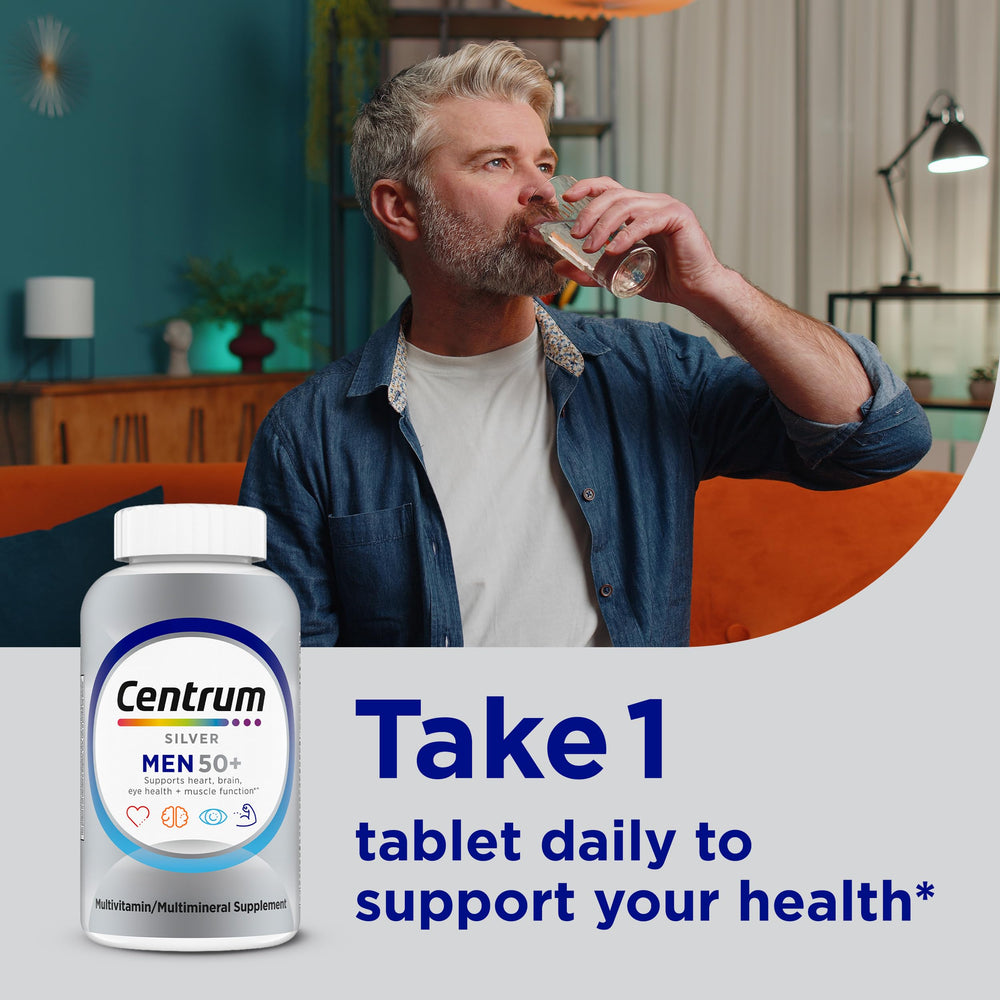 Centrum Silver Men 50+ bottle on a desk suggests daily health routine.