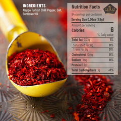 Close-up of crushed Aleppo Pepper flakes with bright color and fruity undertones.