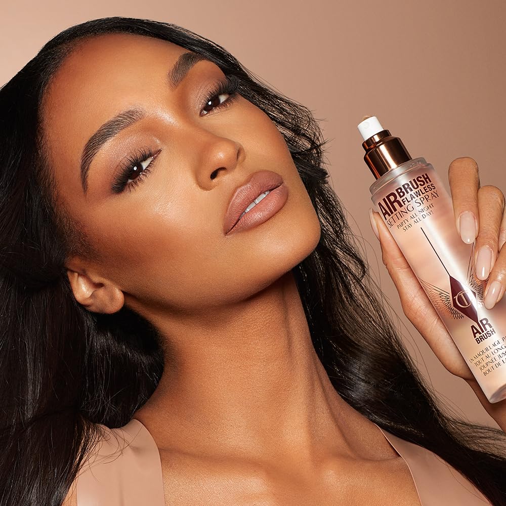 Charlotte Tilbury mist refreshing makeup mid-day for a subtle glow.