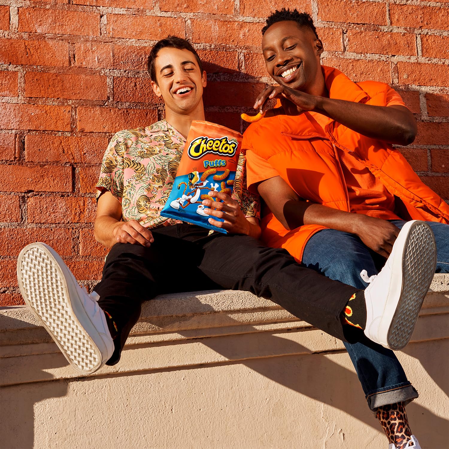 Cheetos dust on fingers close-up inviting a playful snack ritual.