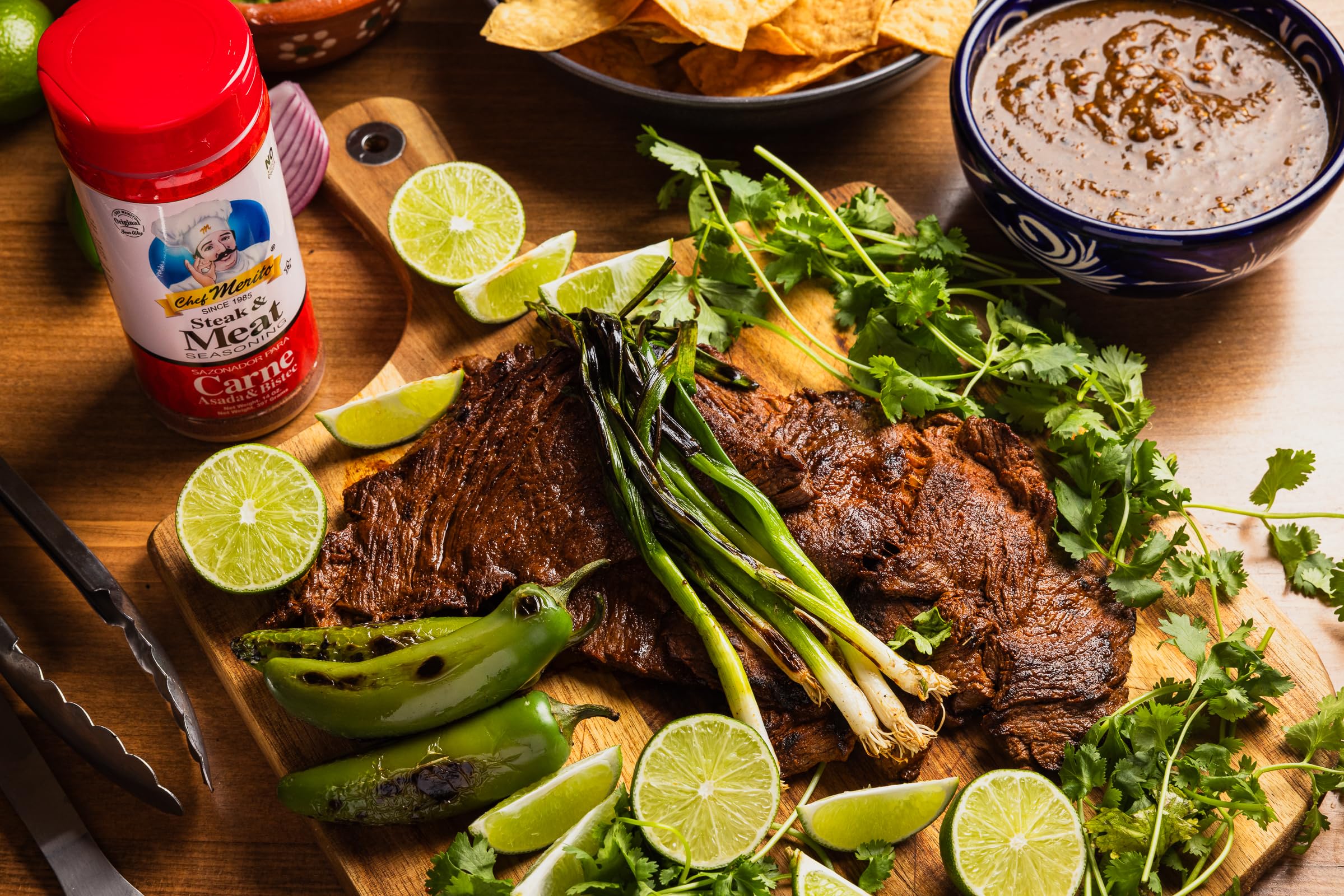 Pouring Chef Merito Carne Asada seasoning over steak