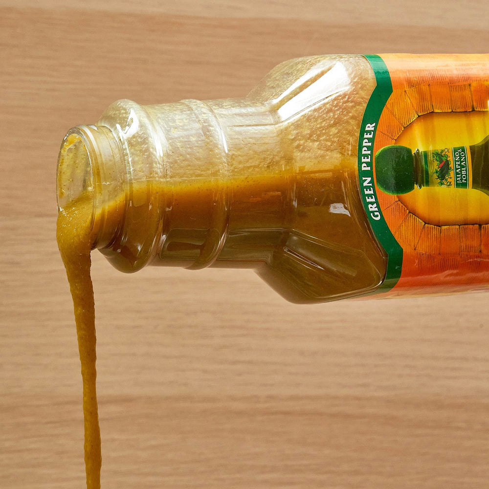 Cholula Green Pepper bottle on a prep station ready for dipping.