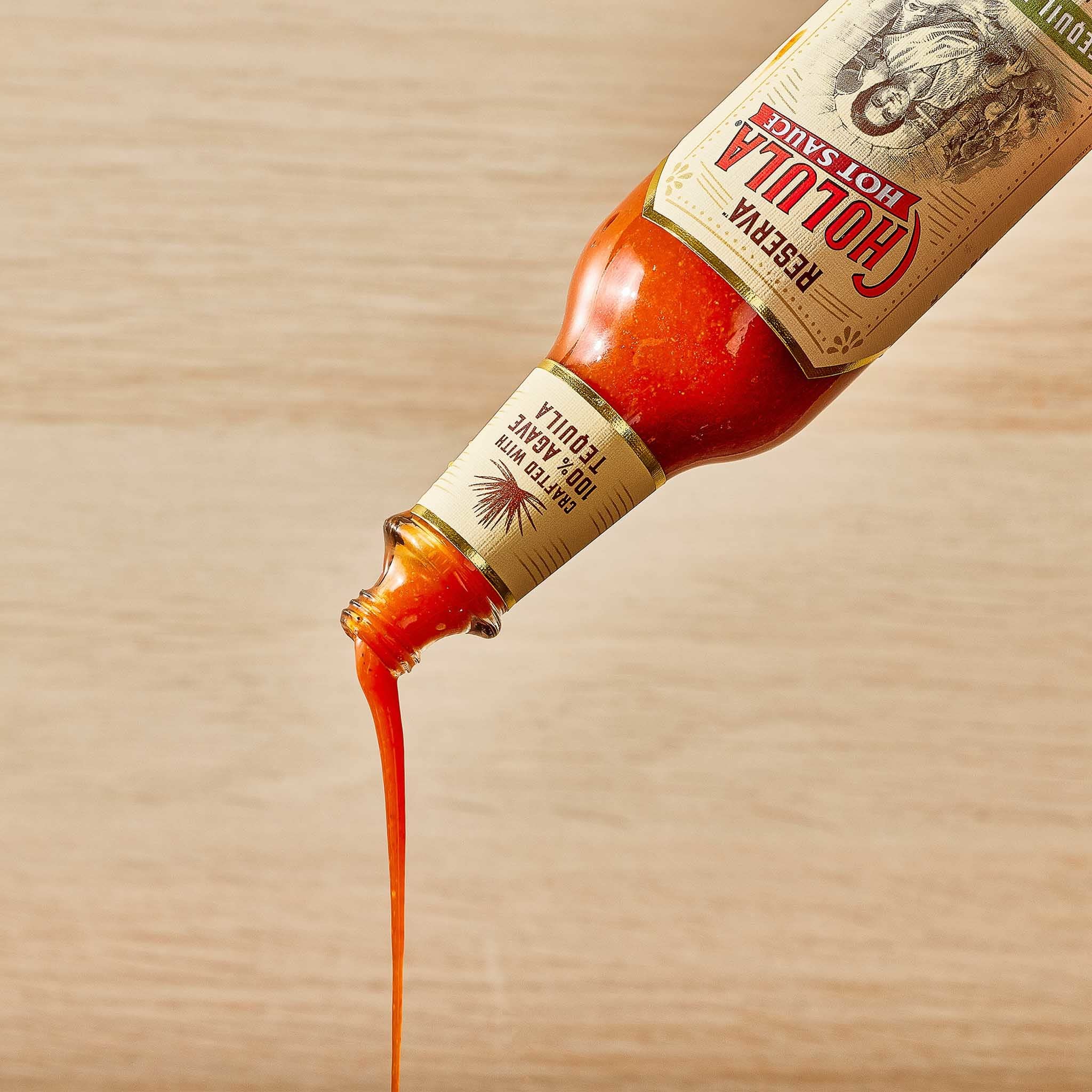 Kitchen shelf ready Cholula Tequila & Lime Reserva to spice meals.