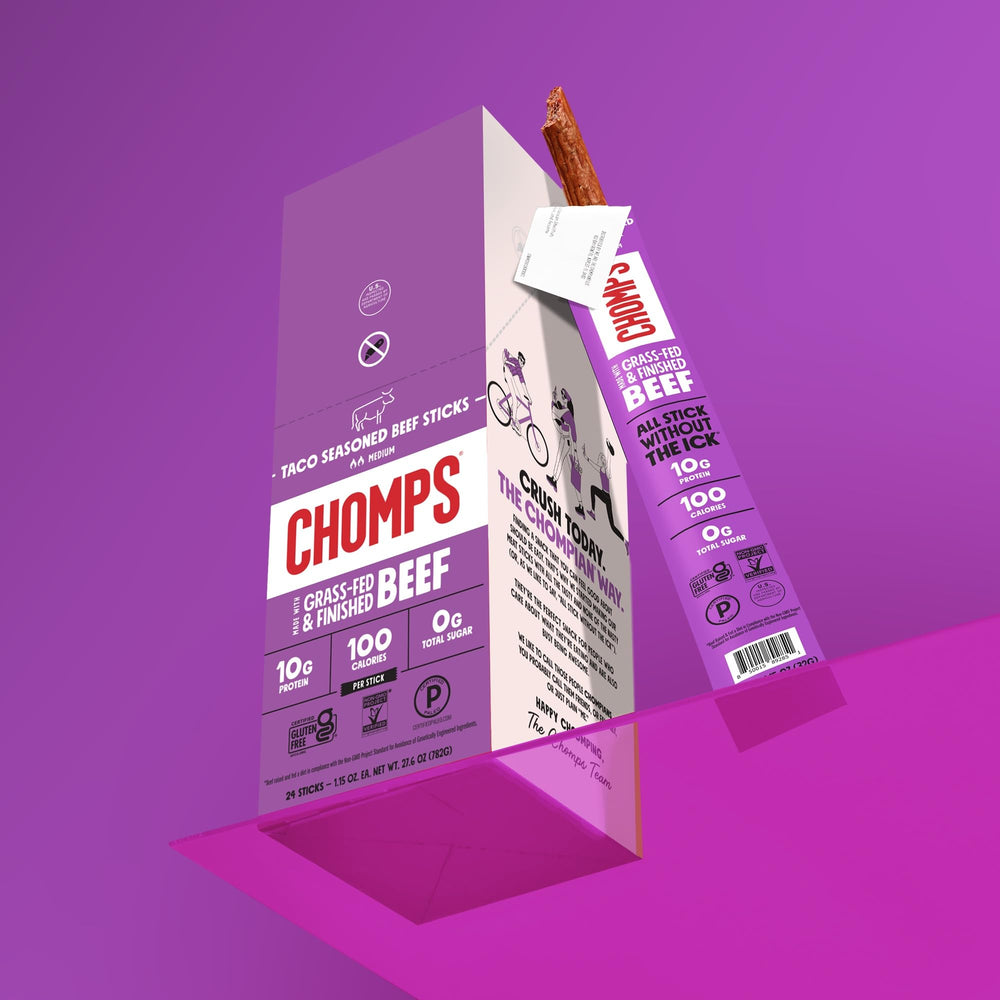 Chomps grass-fed taco beef jerky on-the-go snack in hand