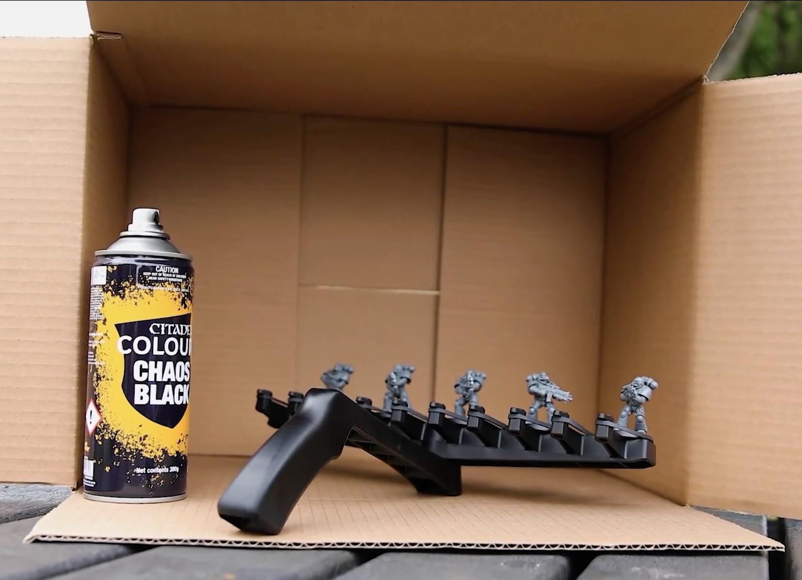 Citadel Chaos Black spray-primer can evenly coats metal miniatures with quick-drying properties.