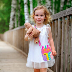Civan Small Pop Purse unicorn side view highlighting compact, portable design for on-the-go use.