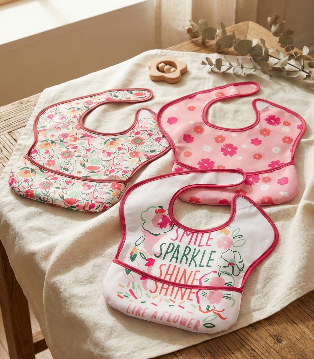 Civarua Kids pink floral bib wearing a toddler catching drips