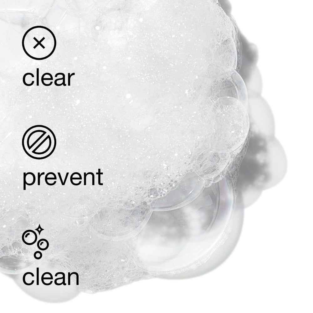 Hands applying Clinique cleanser on damp skin for gentle cleanse.