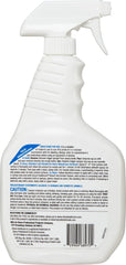 Healthcare worker applies spray to a stainless steel surface.