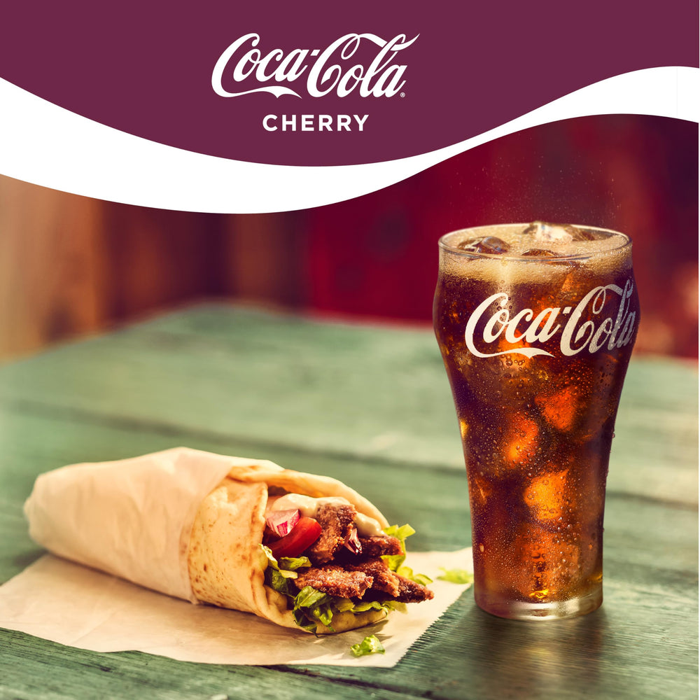 Coca-Cola Cherry Coke poured into a glass with ice for a crisp, chill experience.
