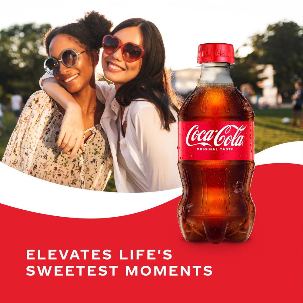 Coca-Cola condensation on bottle signals cool, thirst-quenching refreshment.